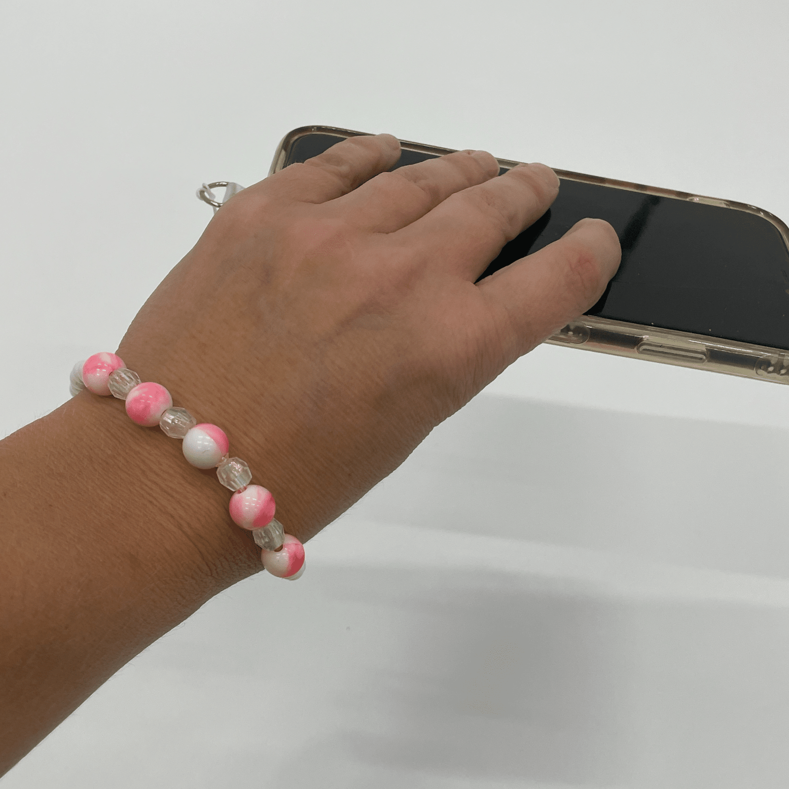 pink phone strap on wrist