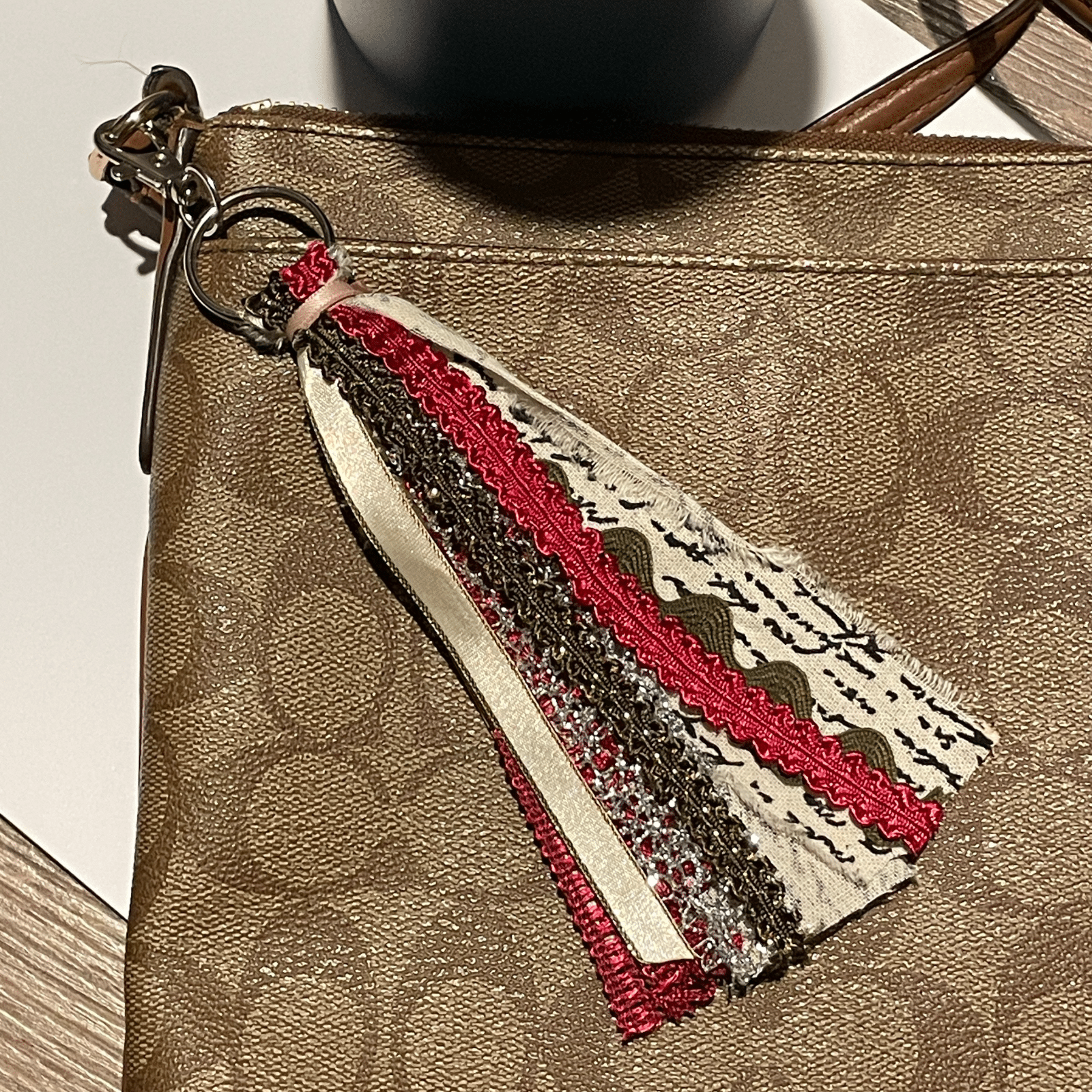 Red tassel keychain on purse