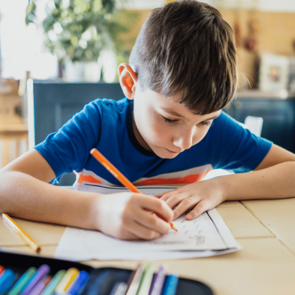 Young boy doing homework at a desk.