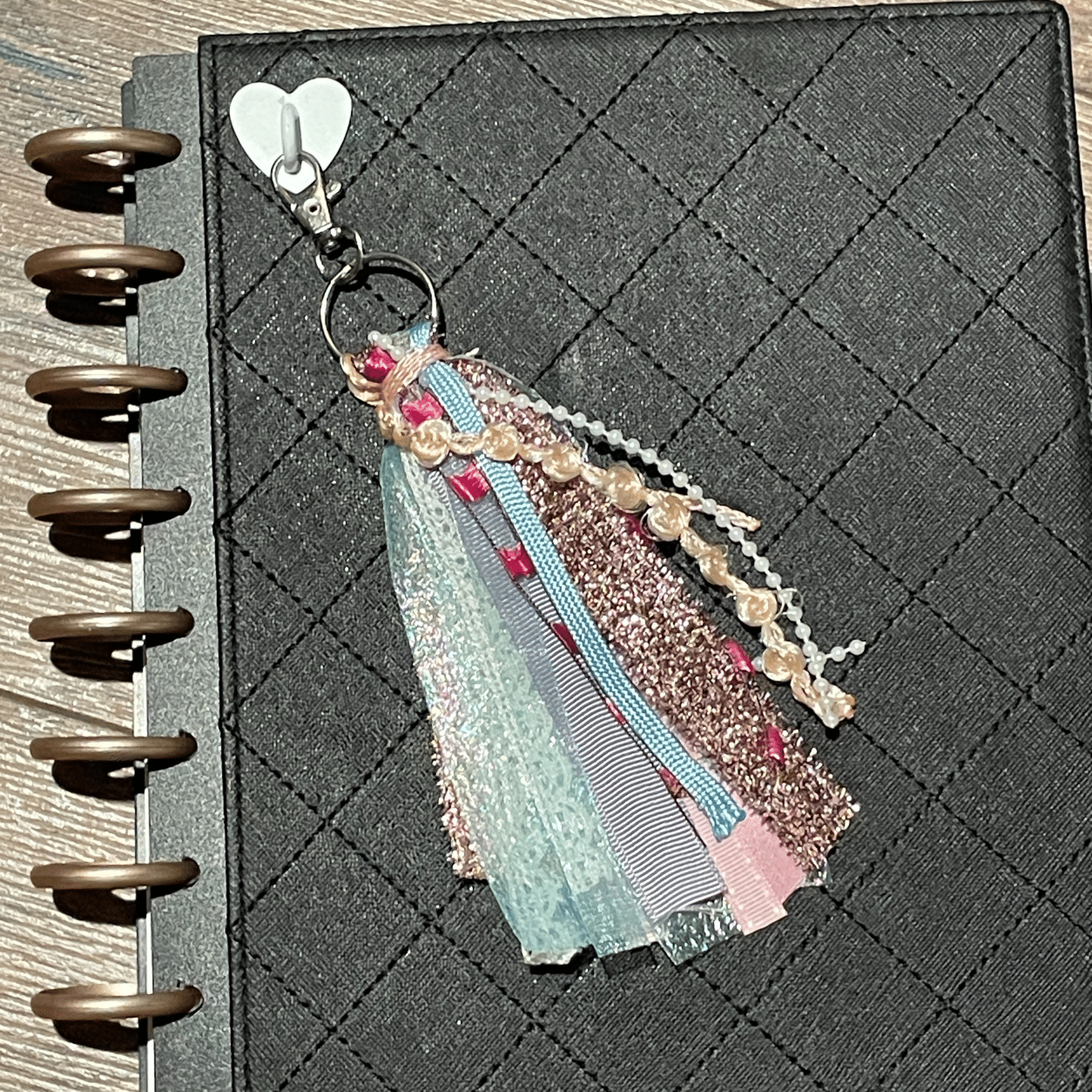 pink tassel keychain on journal