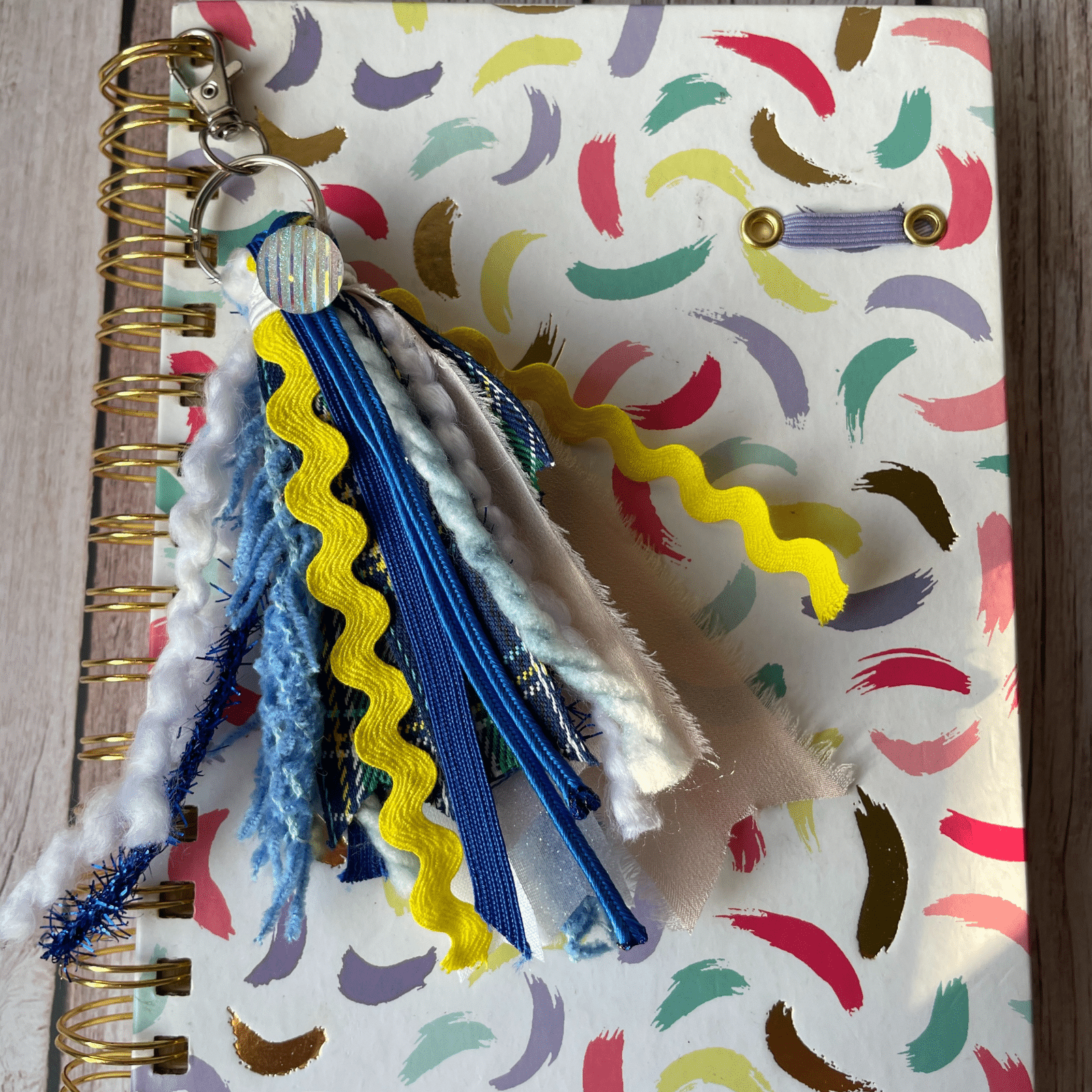 Blue Yellow keychain on journal