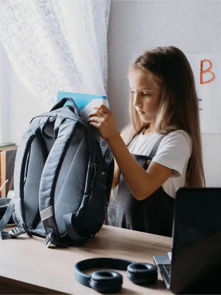 Girl packing her backpack